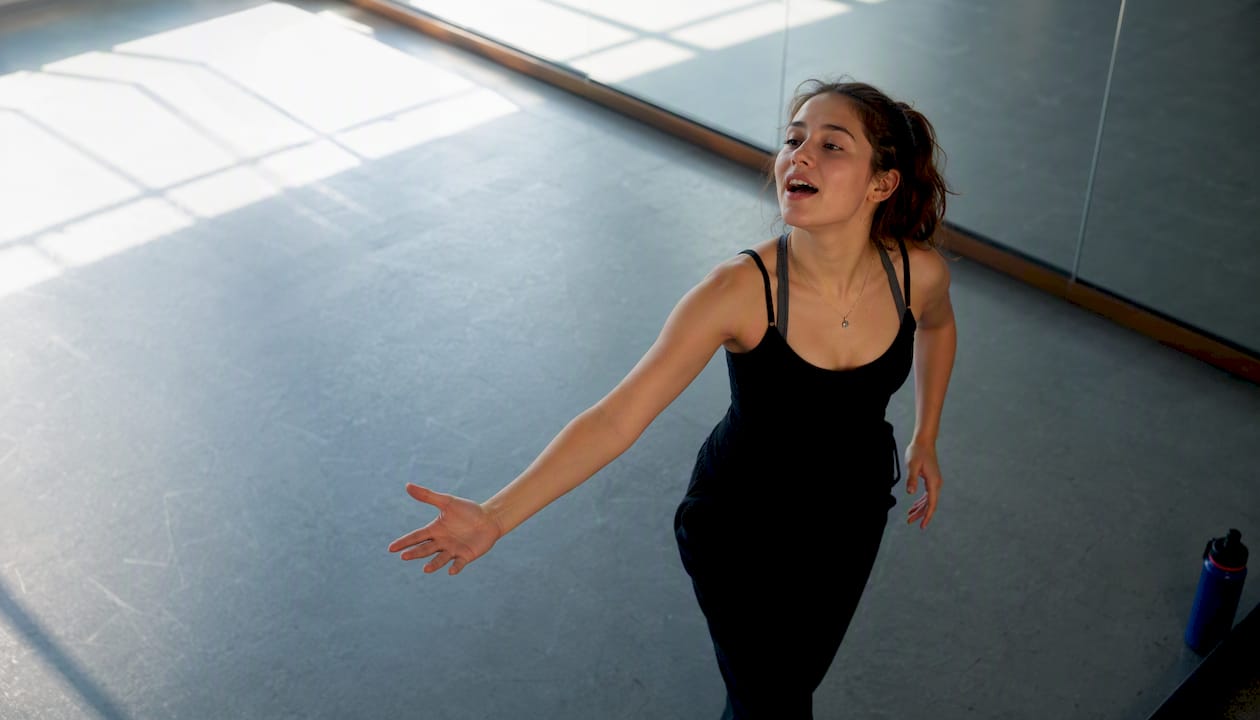 Teen performer combining singing and movement