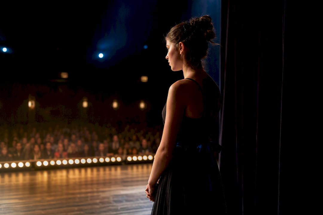 Teen performer facing audience before show
