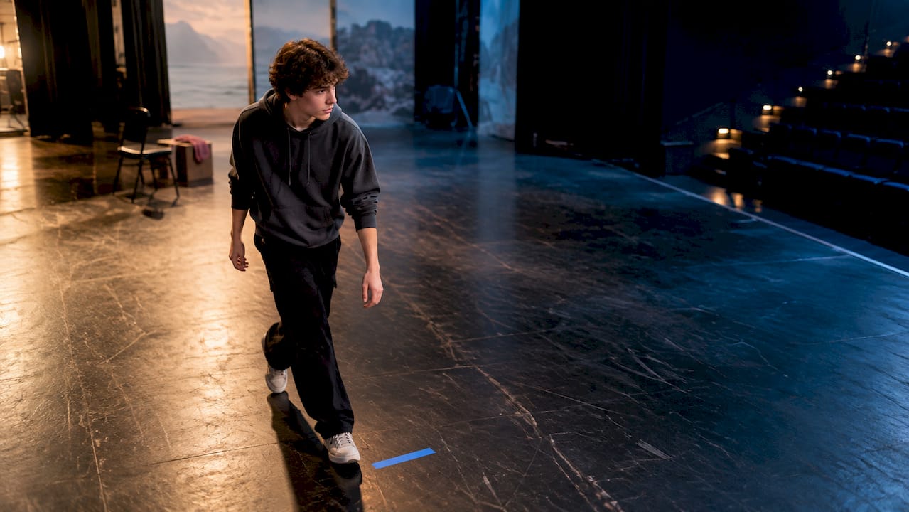 Teen actor rehearsing a stage mark