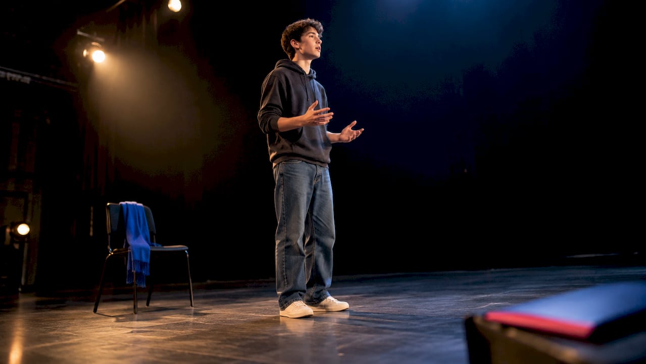 Teen actor rehearsing lines onstage