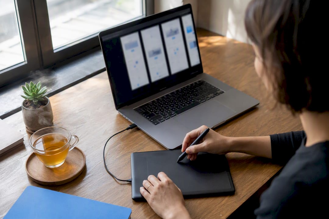 Hands assembling landing page mockups