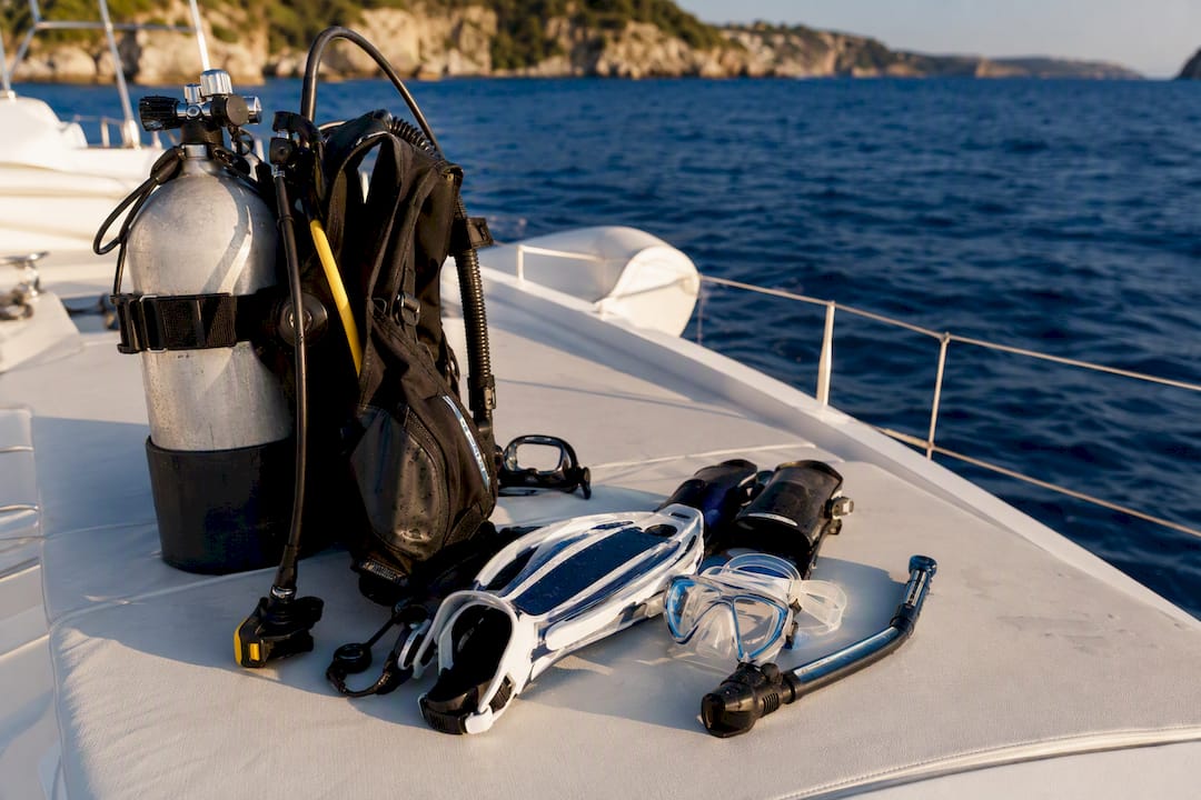 Snorkeling and scuba gear laid out on yacht deck
