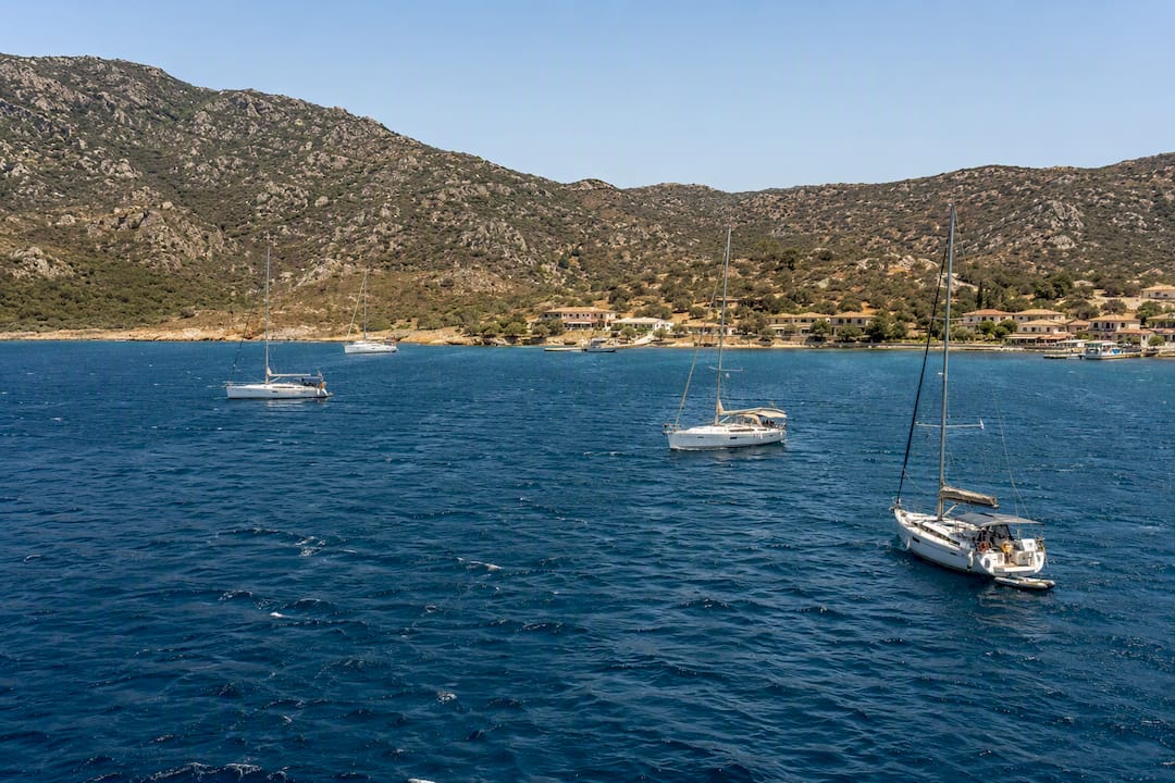 Glassy calm waters in natural harbor at Porto Koufo