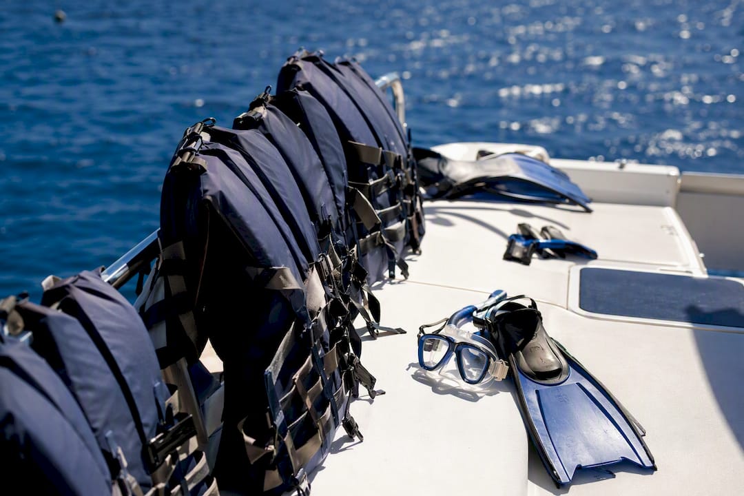 Lifejackets and snorkel gear on yacht deck
