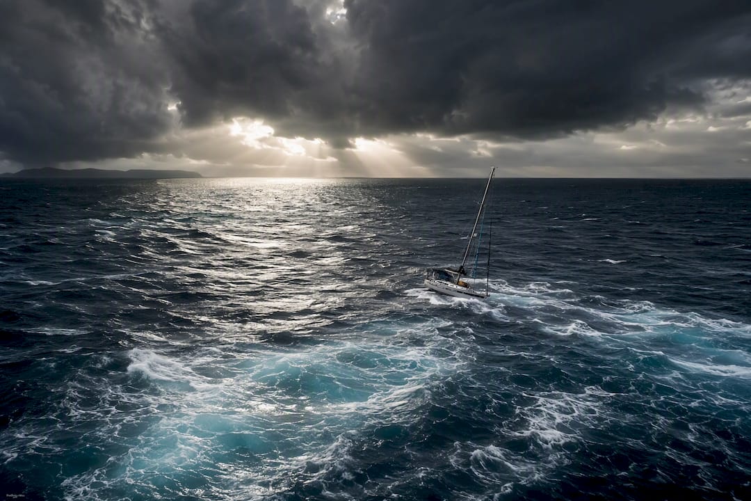 Sailing yacht near storm clouds