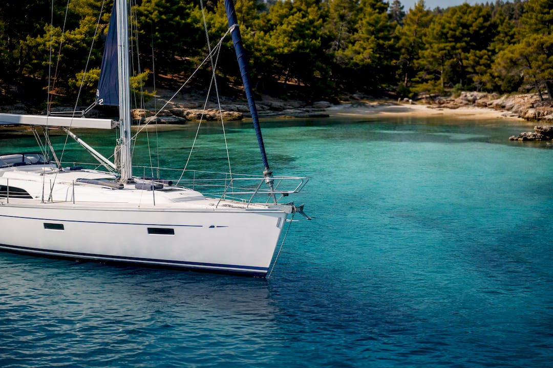 Yacht anchored in shallow sandy lagoon