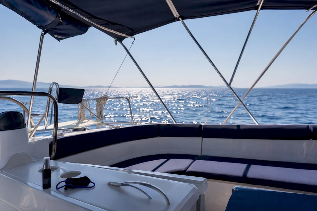 Shaded yacht cockpit under bimini with sunglasses