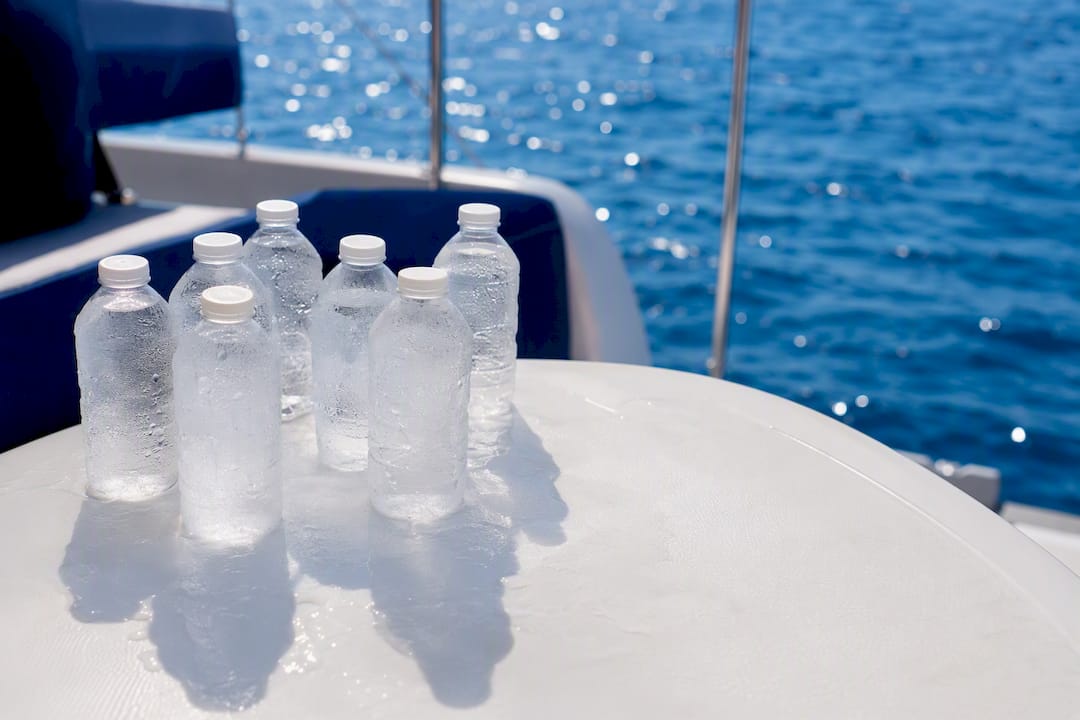 Frozen water bottles as ice packs in cooler on yacht