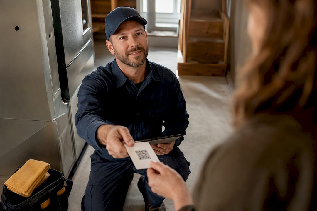Technician handing customer a review request card