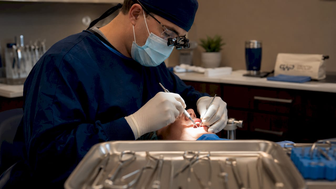 Close-up of surgical tooth extraction procedure