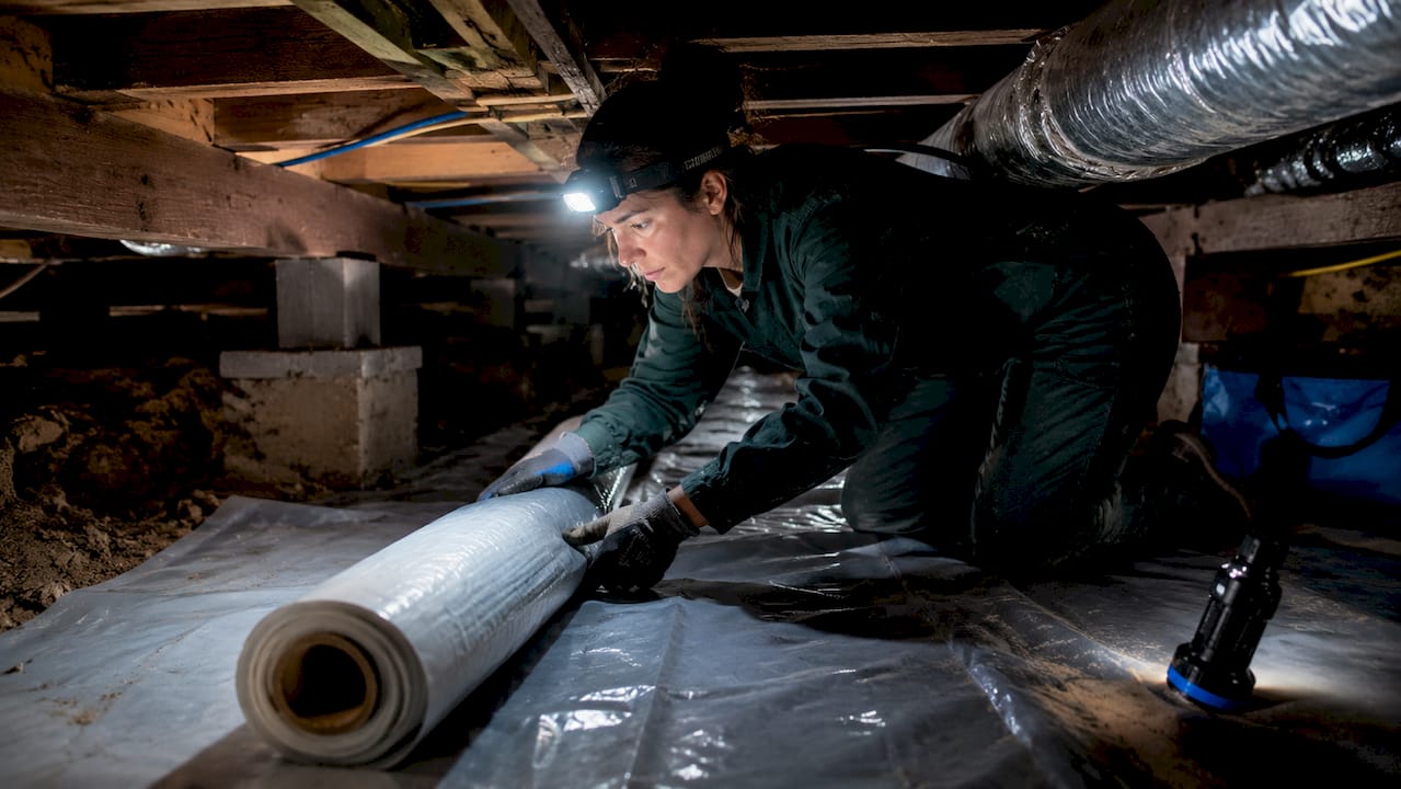 Technician working in tight crawl space area