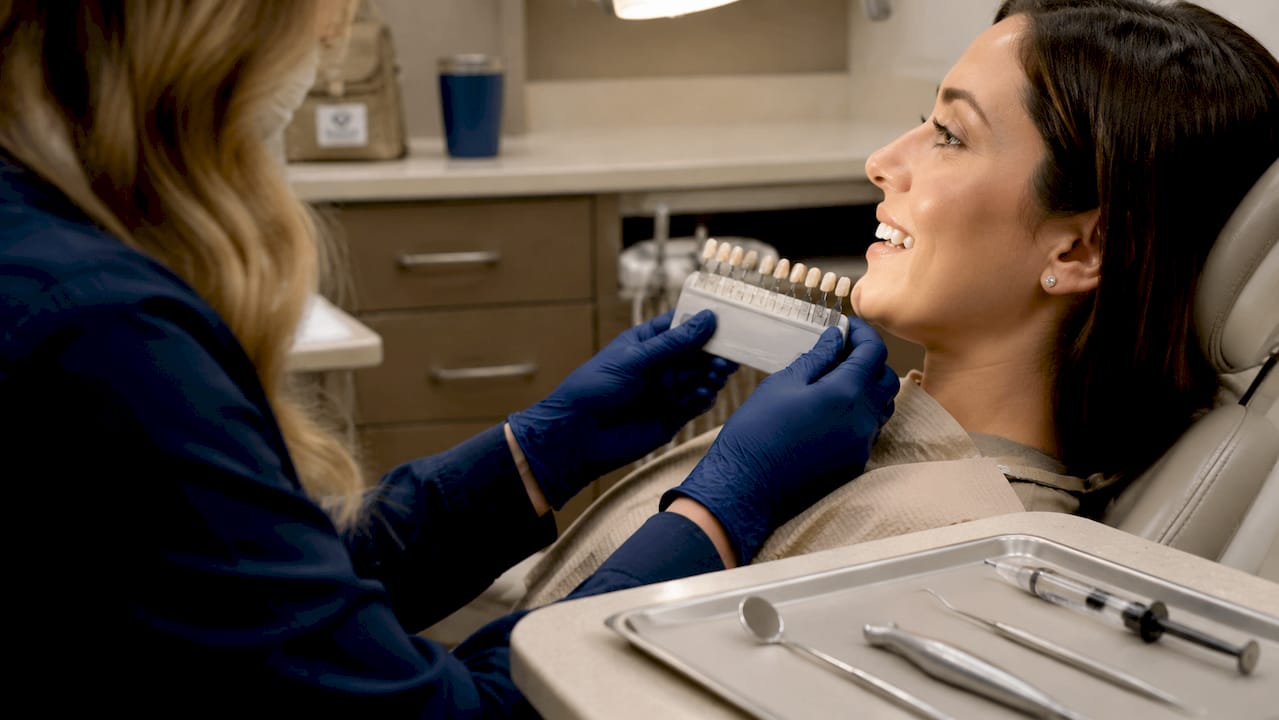 Close-up of dental hands matching tooth shade