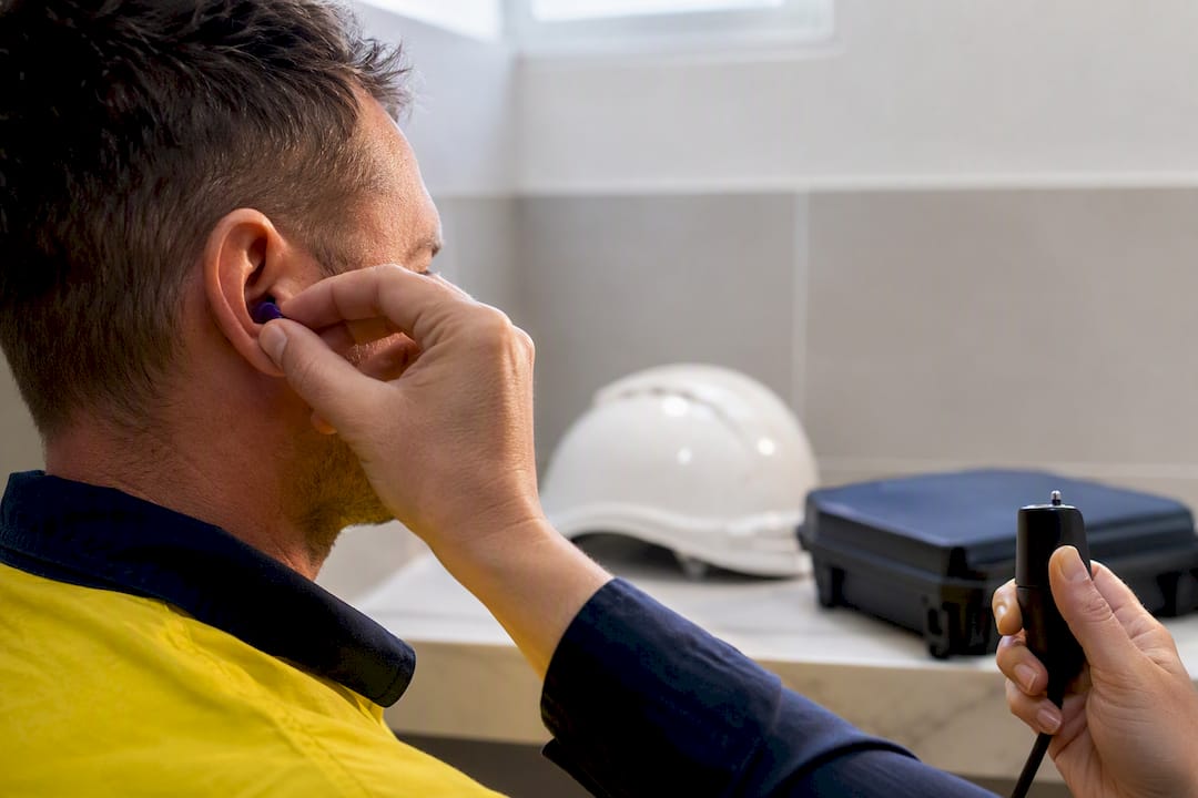 Worker undergoing hearing protector fit testing