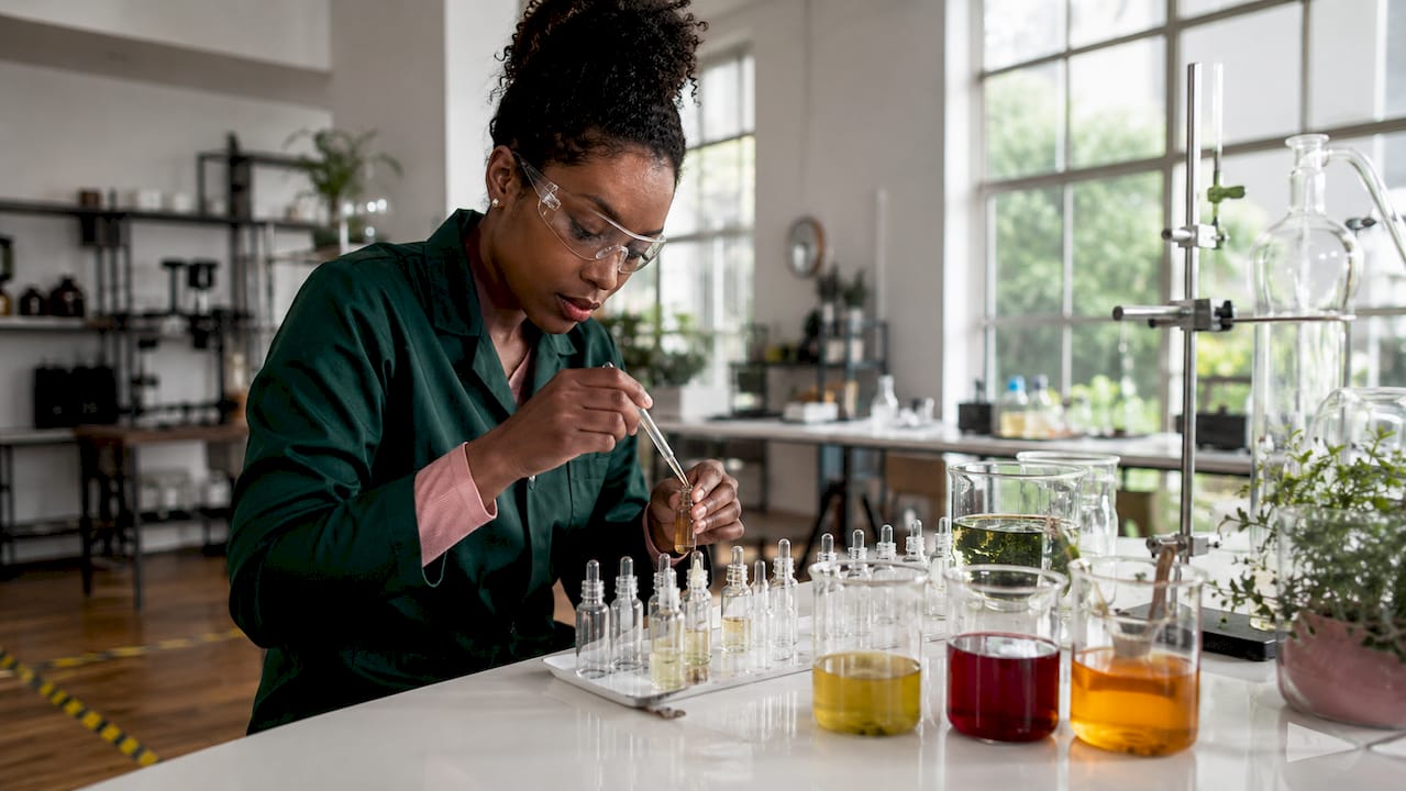 Scientist working with botanical skincare lab vials