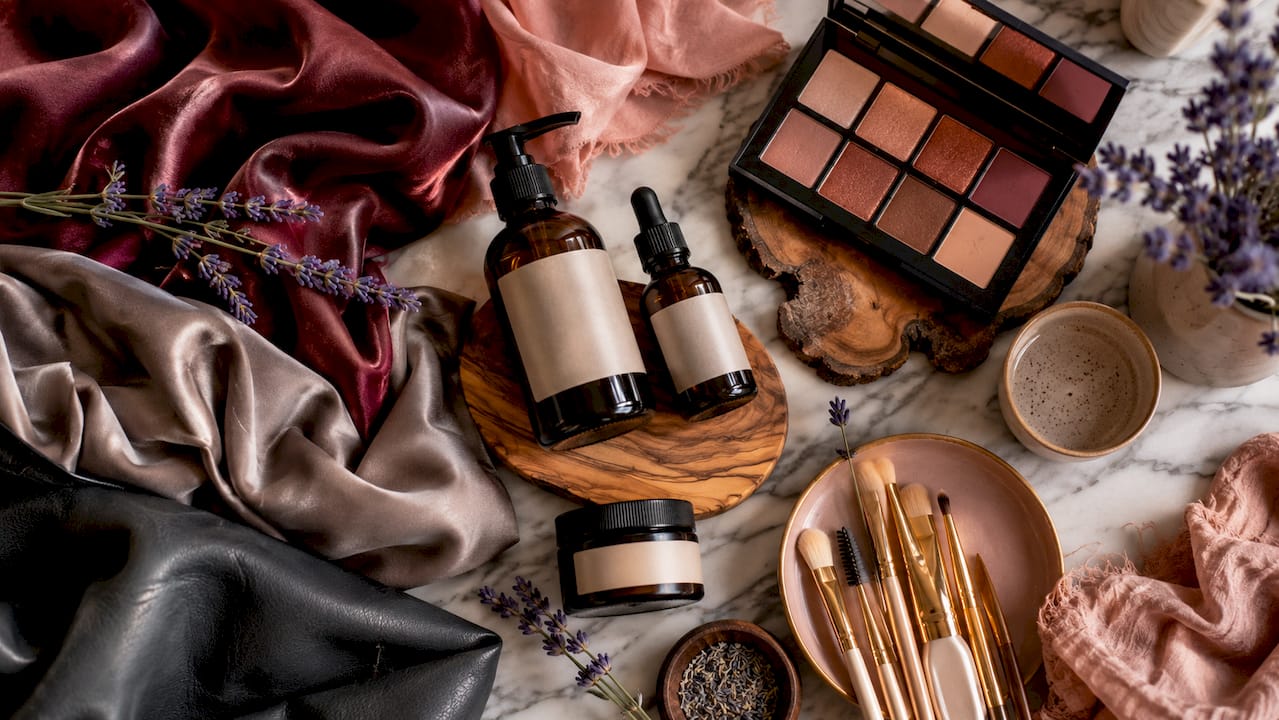 Flat lay of beauty products and textured fabrics