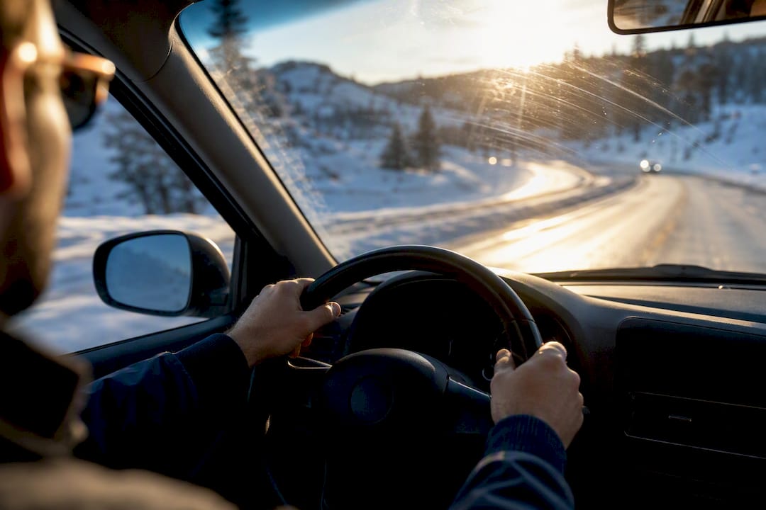 Sun glare across a snowy driving route