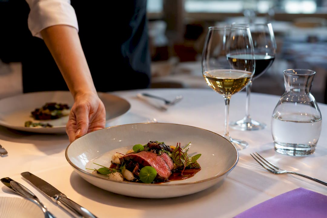 Plated courses and wine at hotel dinner