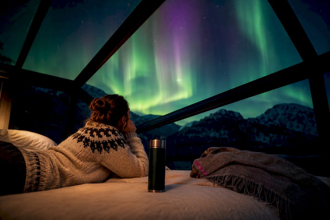 Aurora viewed through a Tromsø glass cabin