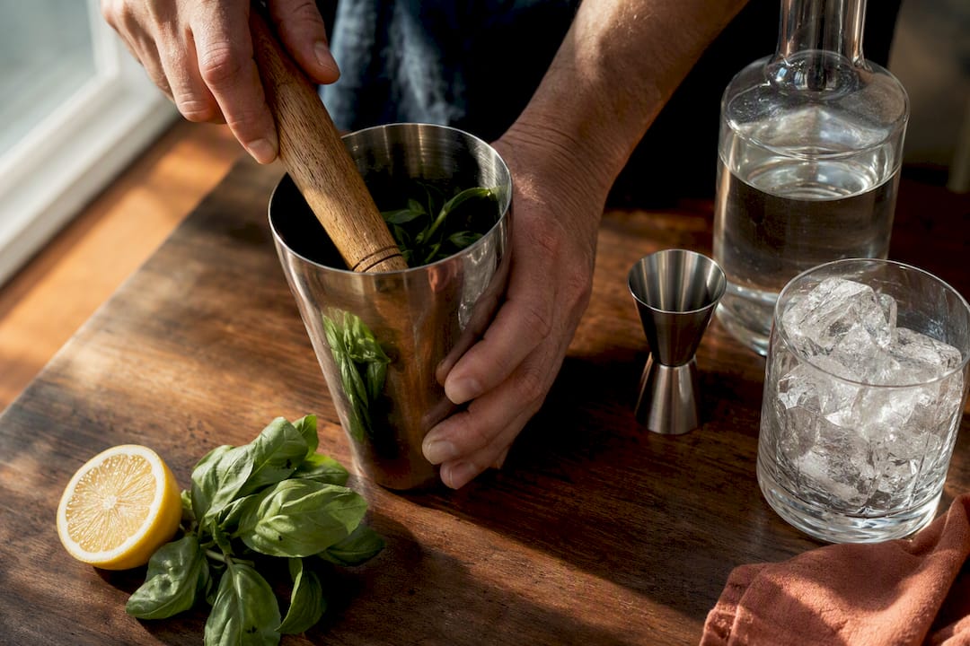 Basil leaves muddled for gin cocktail