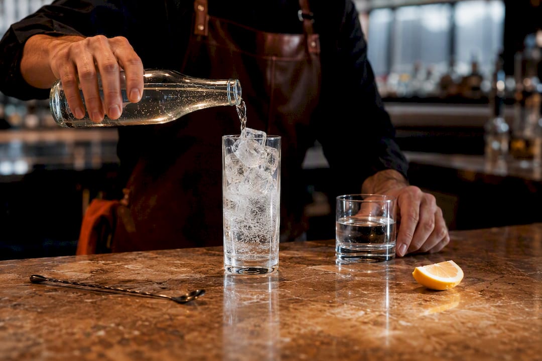 Bartender preparing a simple spirit and soda