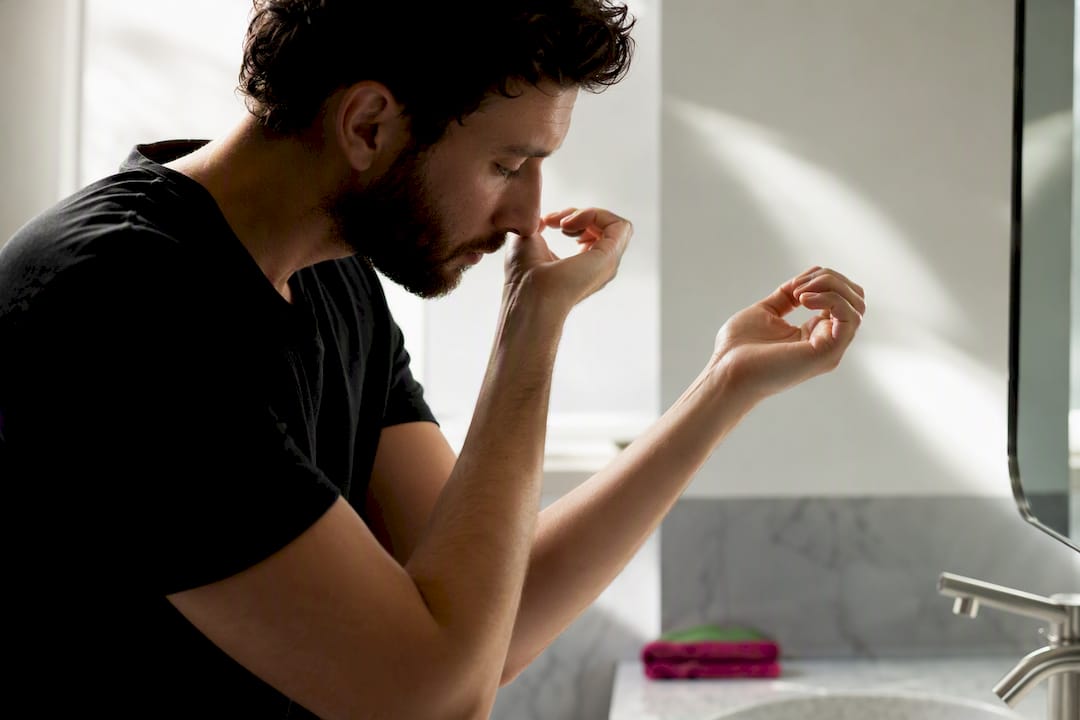 Person comparing two fragrance applications