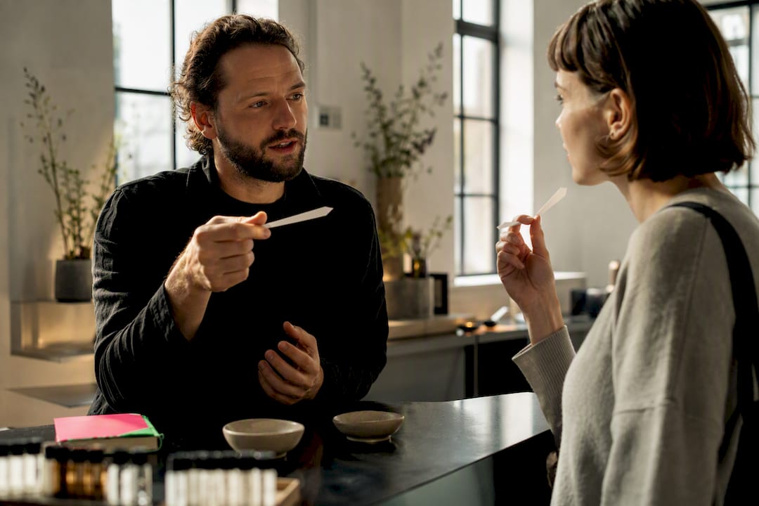 Perfumer explaining a scent at pop-up fair