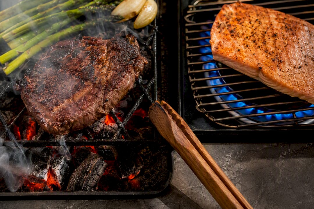 Food over charcoal and gas heat sources