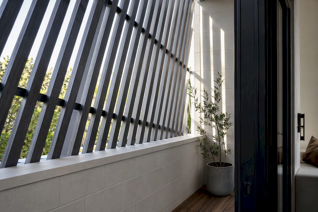 Daylight filtering through angled privacy slats