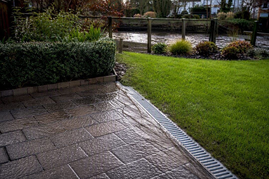 Surface water flowing toward garden drainage