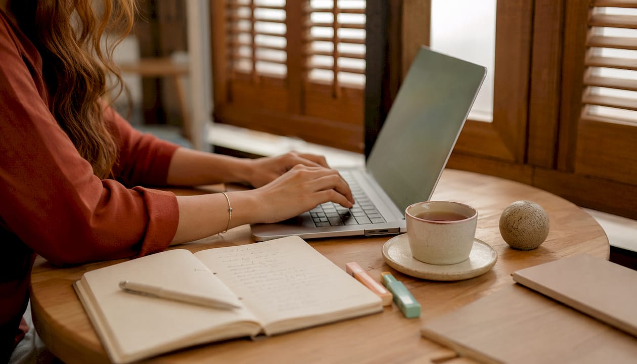 Hands typing at desk optimizing business profile