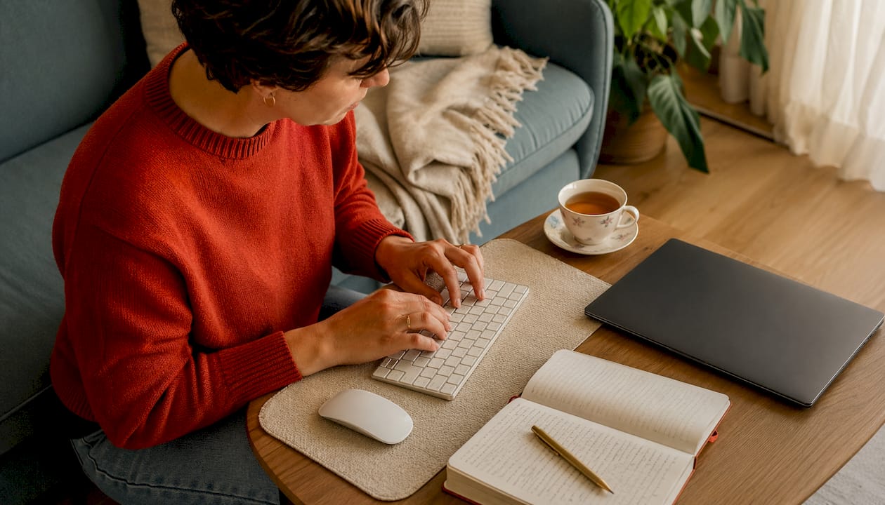 Side view of hands typing in soft workspace