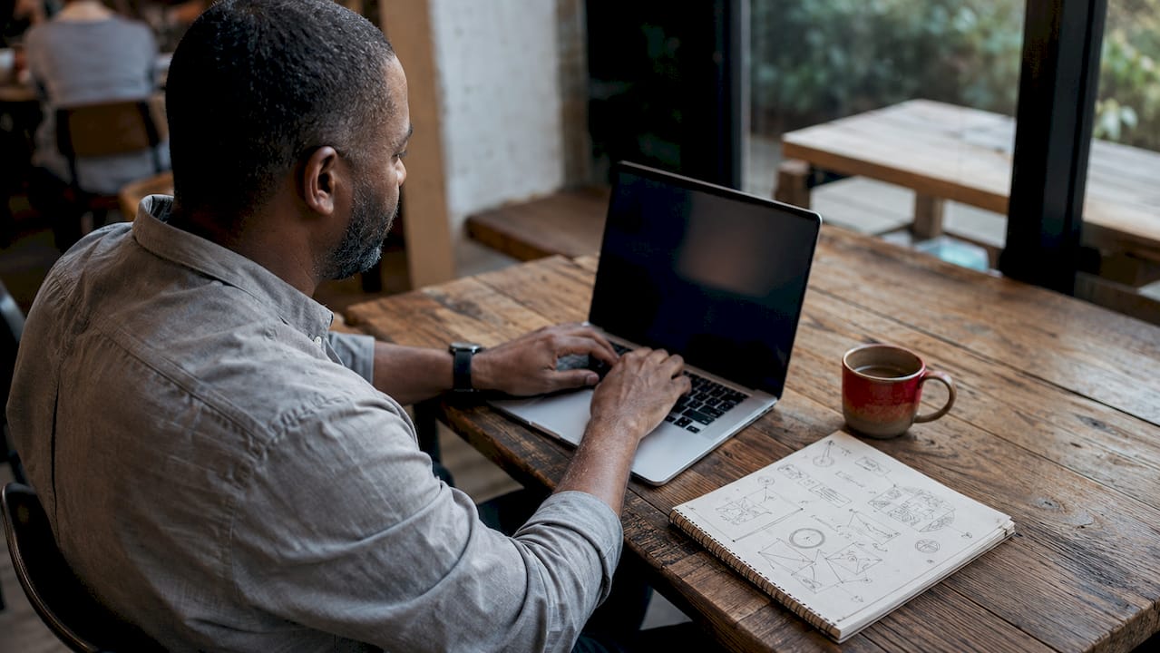 Psychology Principles for E-Commerce: Boost Conversions Hands typing on laptop in coworking space