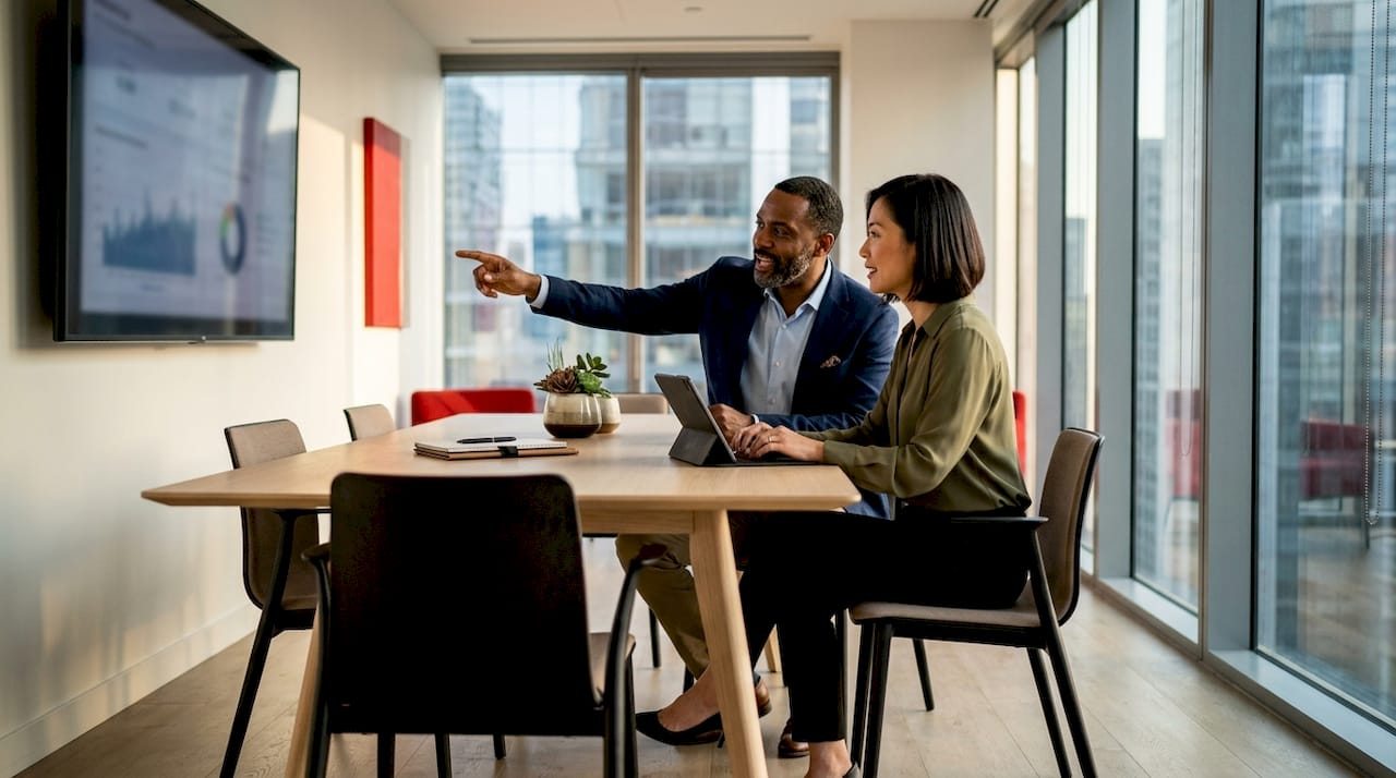 Affordable Luxury Marketing Tactics Guide for 2026 Two strategists discussing luxury brand pricing