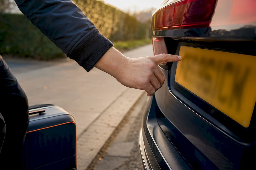 Traveller checking vehicle registration before pickup