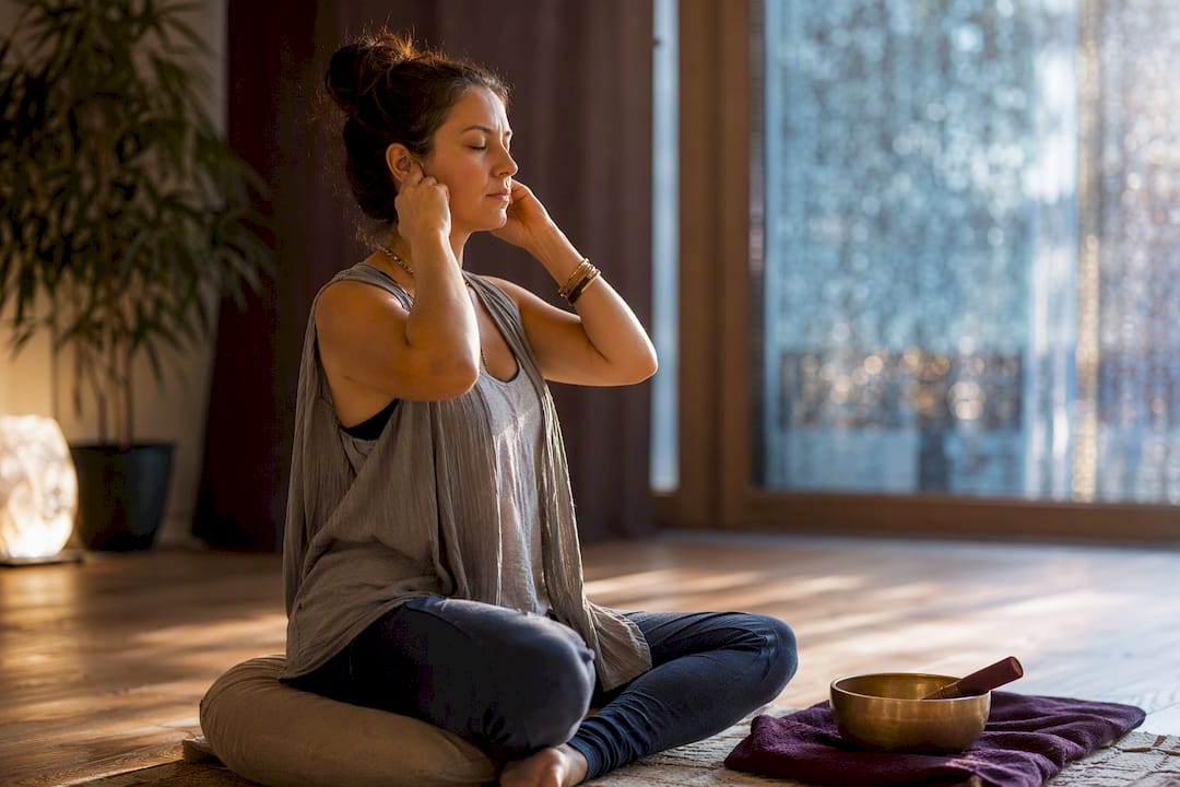 Woman practicing bee breath in quiet studio