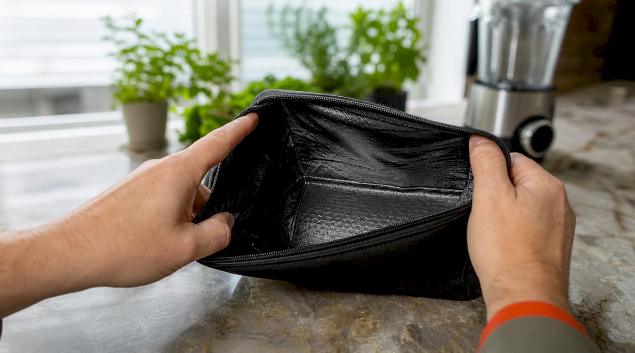 Hands holding carbon-lined smell-proof bag open
