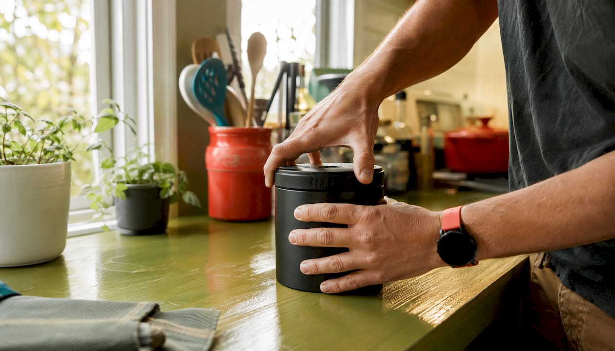 Hands sealing smell-proof container lid