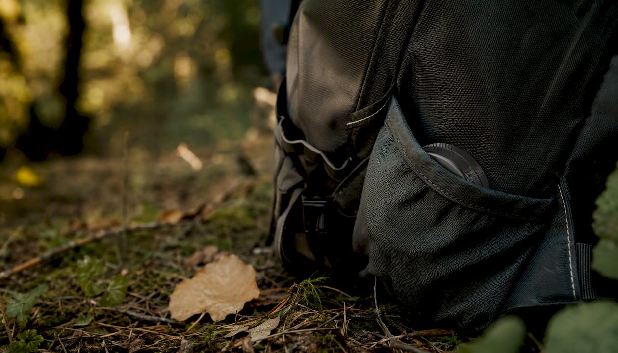 Partial metal grinder visible in jacket pocket