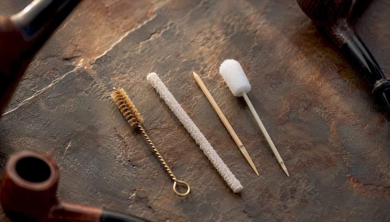 Array of pipe cleaning tools on wooden surface