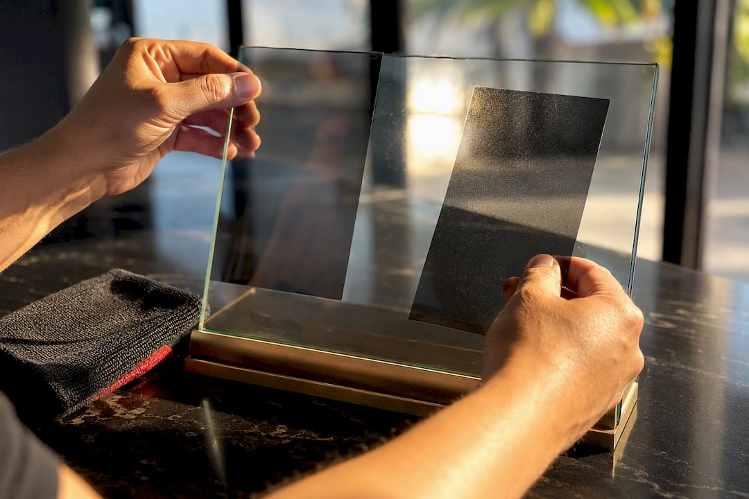Tint film swatches held in sunlight