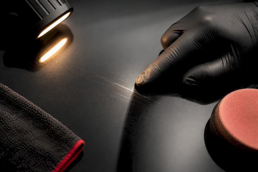 Fingernail testing a deep paint scratch