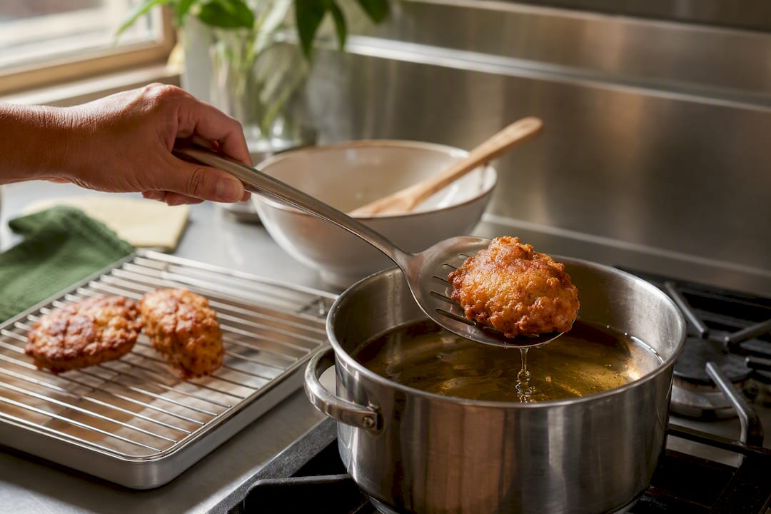 Test fritter lifted from hot oil