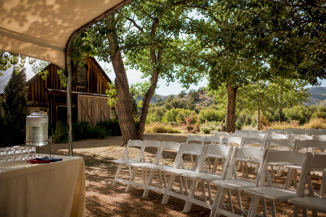 Shaded outdoor ceremony seating beneath trees