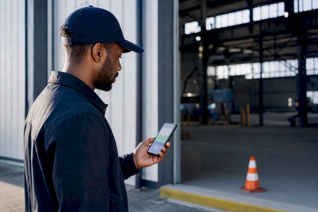 Worker checking location at warehouse entrance