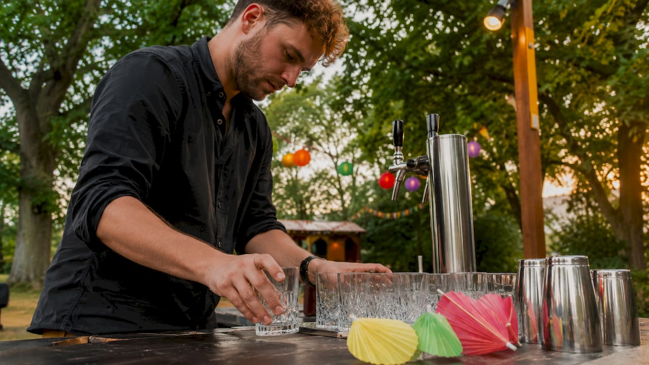 De barman zet de partybar klaar en zorgt dat alle materialen op hun plek staan.