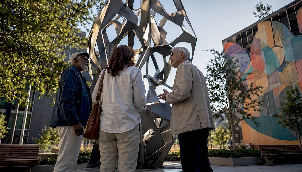 Gallery visitors examining contemporary abstract painting