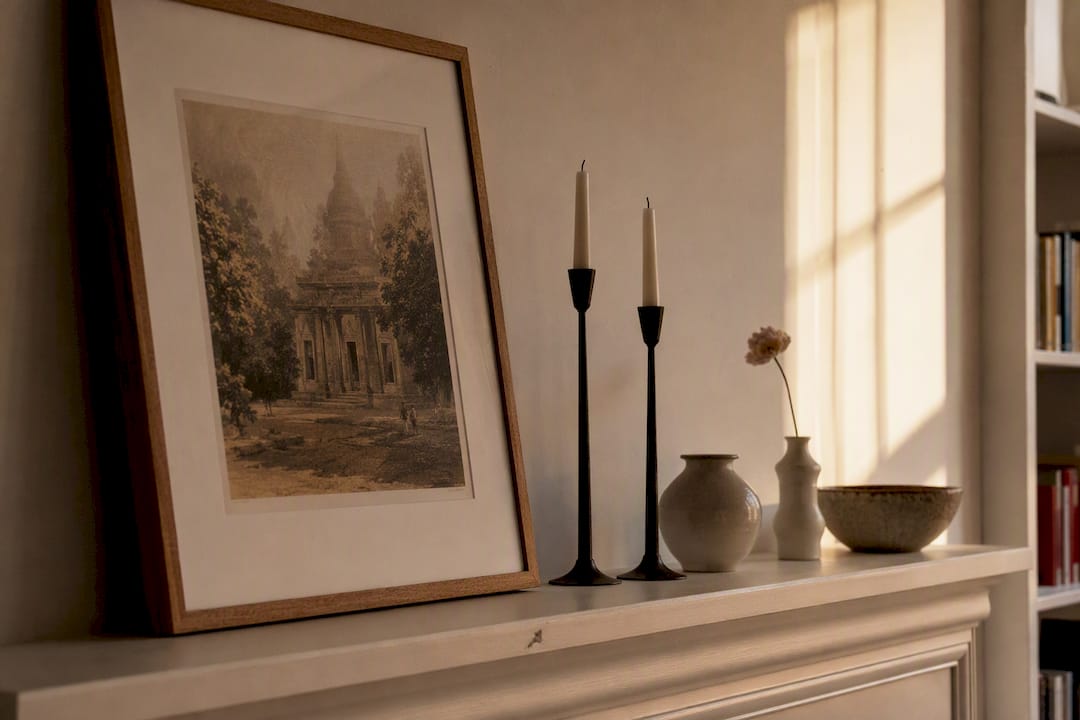 Layered mantel shelf accessories in styled fireplace