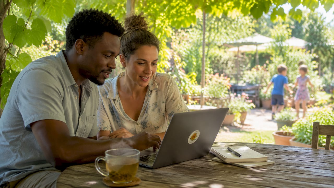 Parents checking nursery licence on laptop