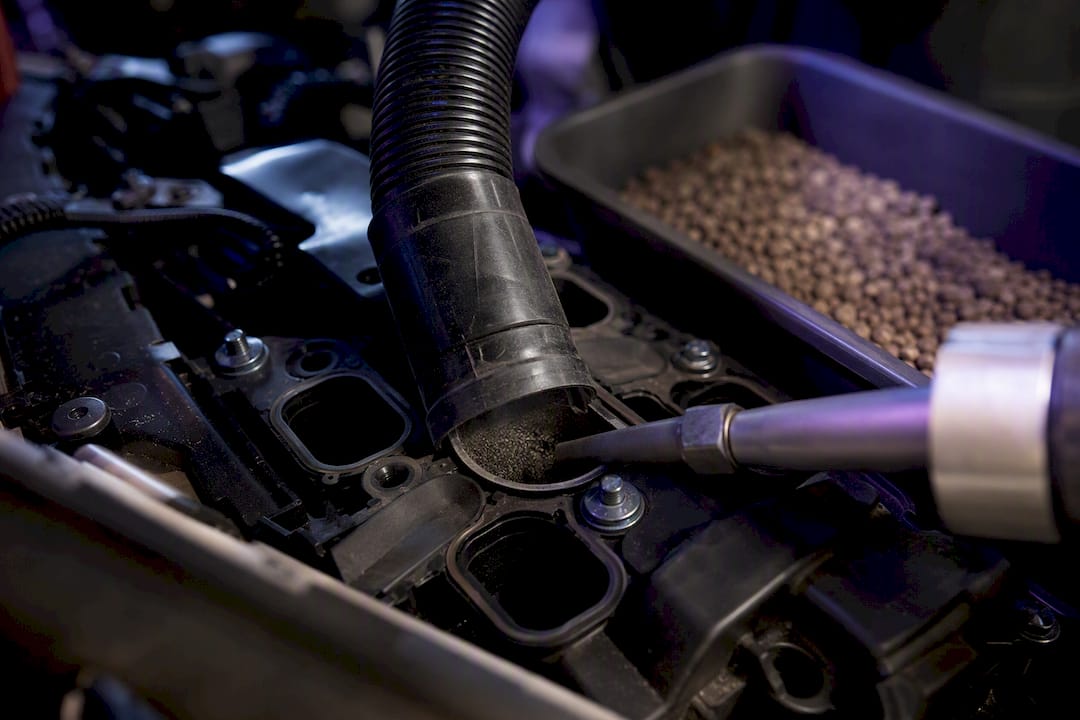 Vacuum hose sealed over intake port during blasting