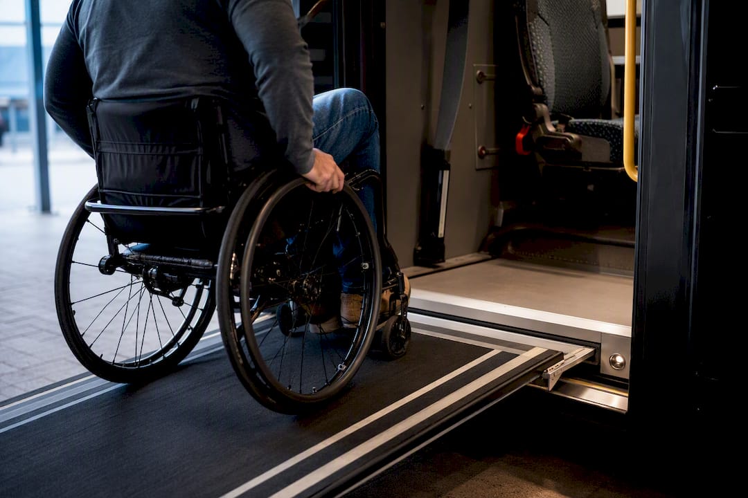 Wheelchair user entering coach via ramp